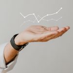 Digital graph performance with businessman hand overlay